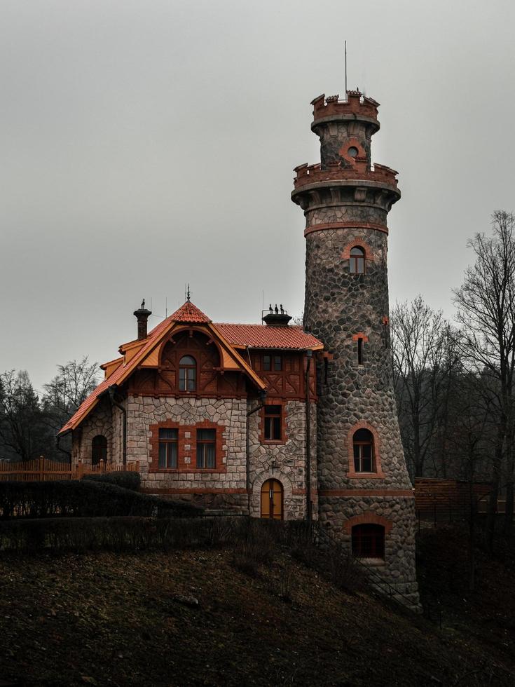 Stone house nearby water tank Les Kralovstvi in Czech republic photo