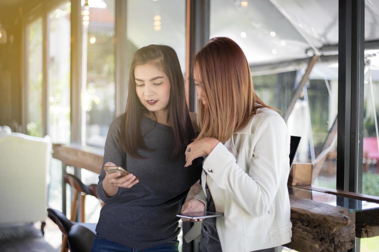 Women looking at smart phone photo