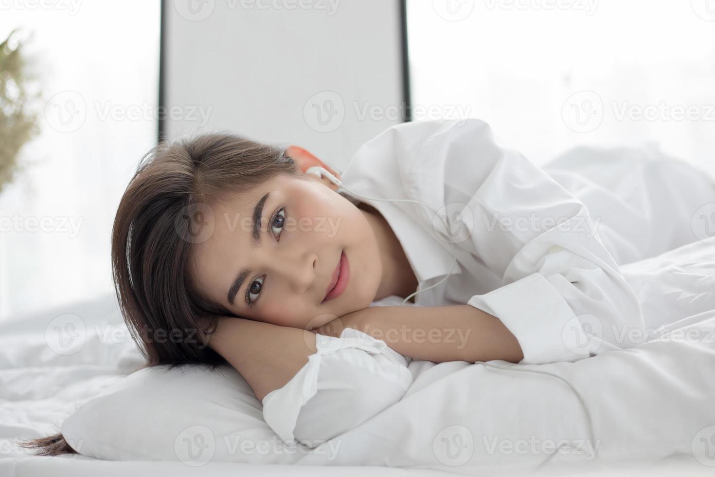 Woman lying in bed photo