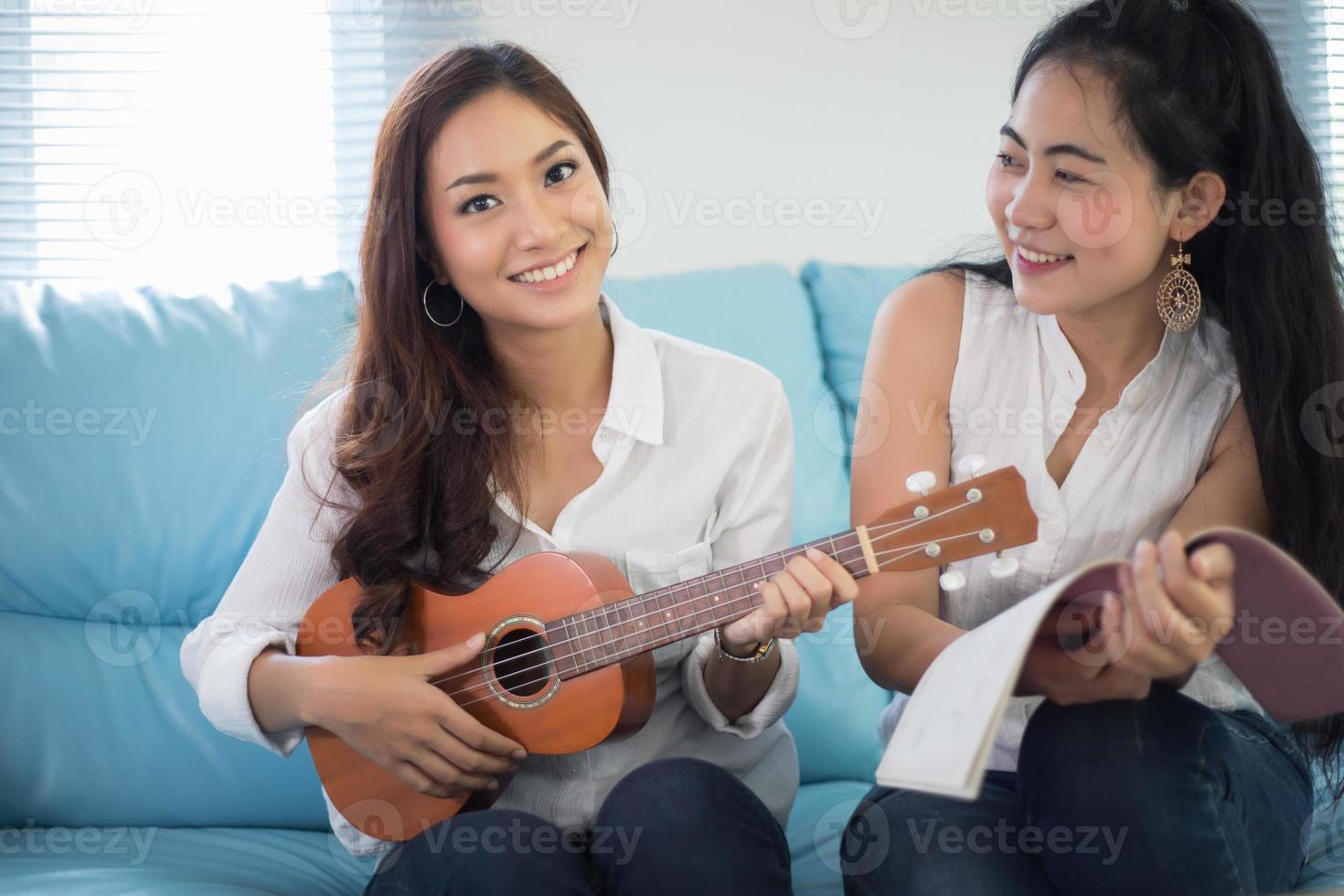 Two friends playing ukelele photo