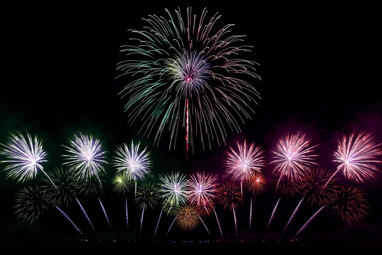 Festive beautiful colorful fireworks display on the sea beach Amazing holiday fireworks party or any celebration event in the dark sky photo