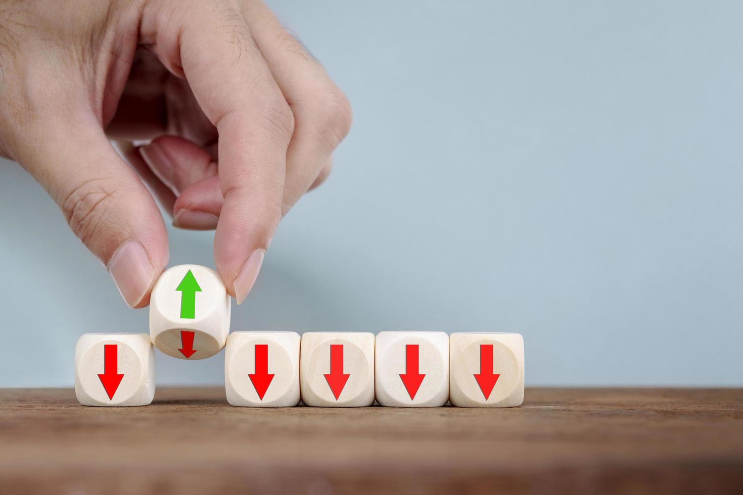 Hand Changing with flipping changes the direction of an arrow on Wooden Cube  Business concept for innovative solution photo