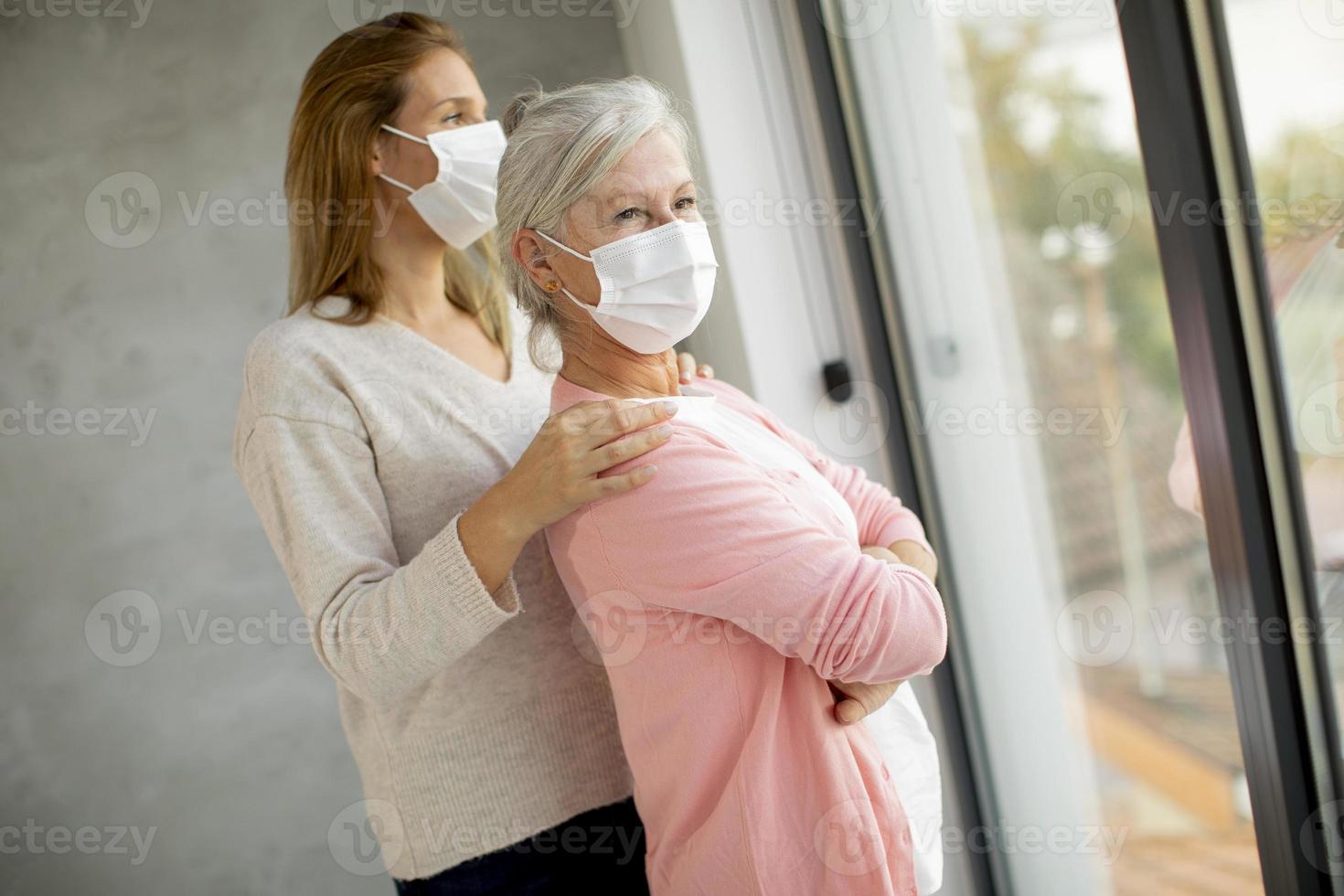 Mature masked mother and daughter photo