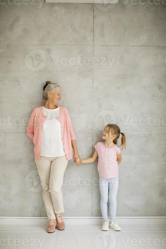 Grandmother holding granddaughter's hand with copy space photo