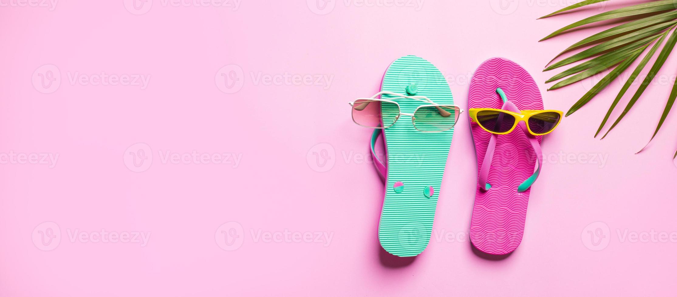 Summer hat with flip flop on pink background photo