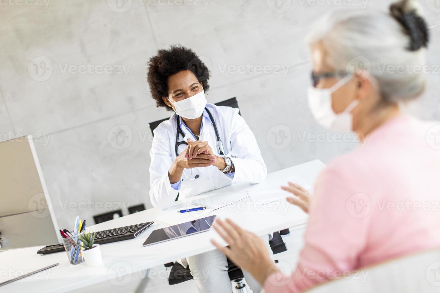 Doctor talking to mature woman photo