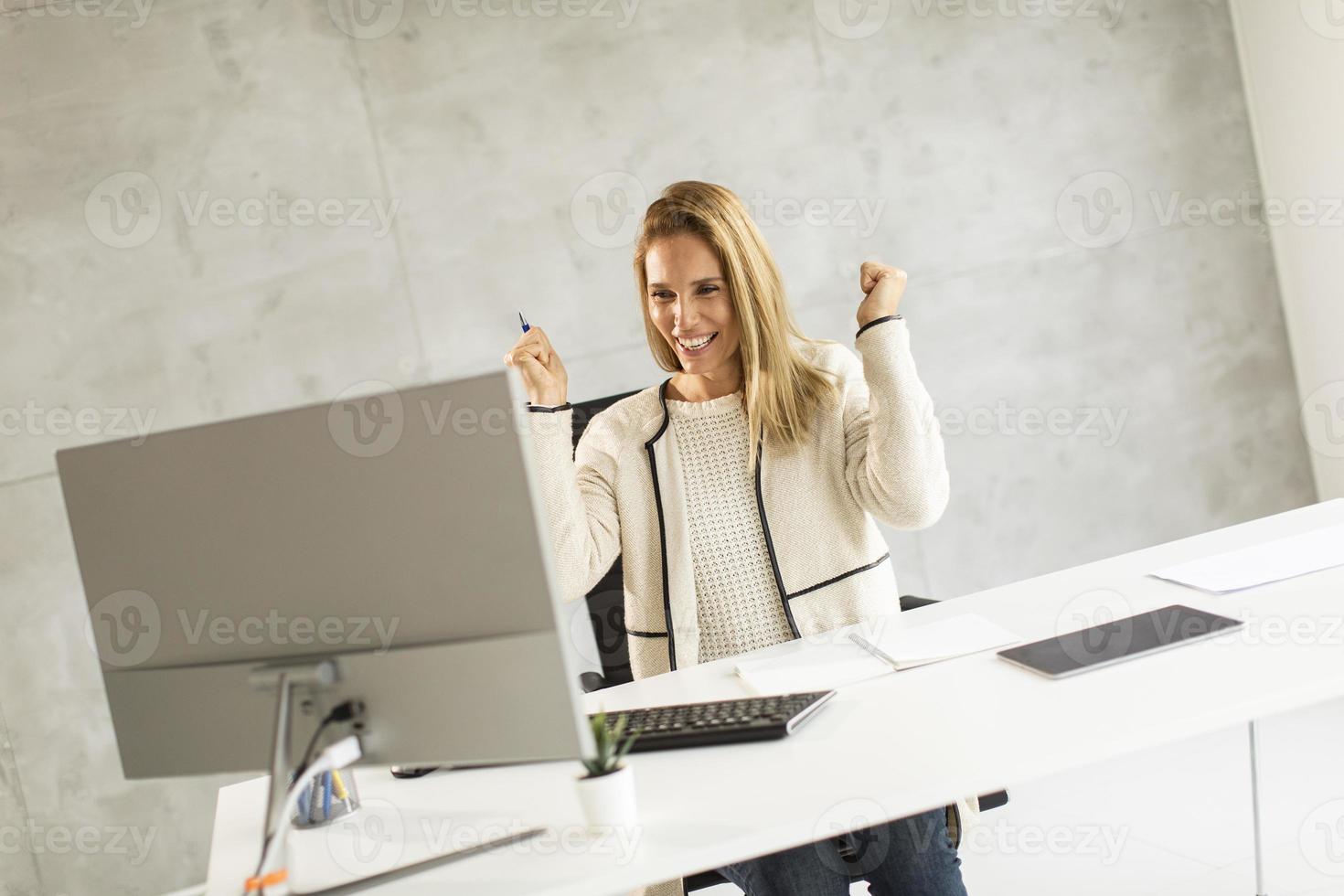 Businesswoman excited at work photo