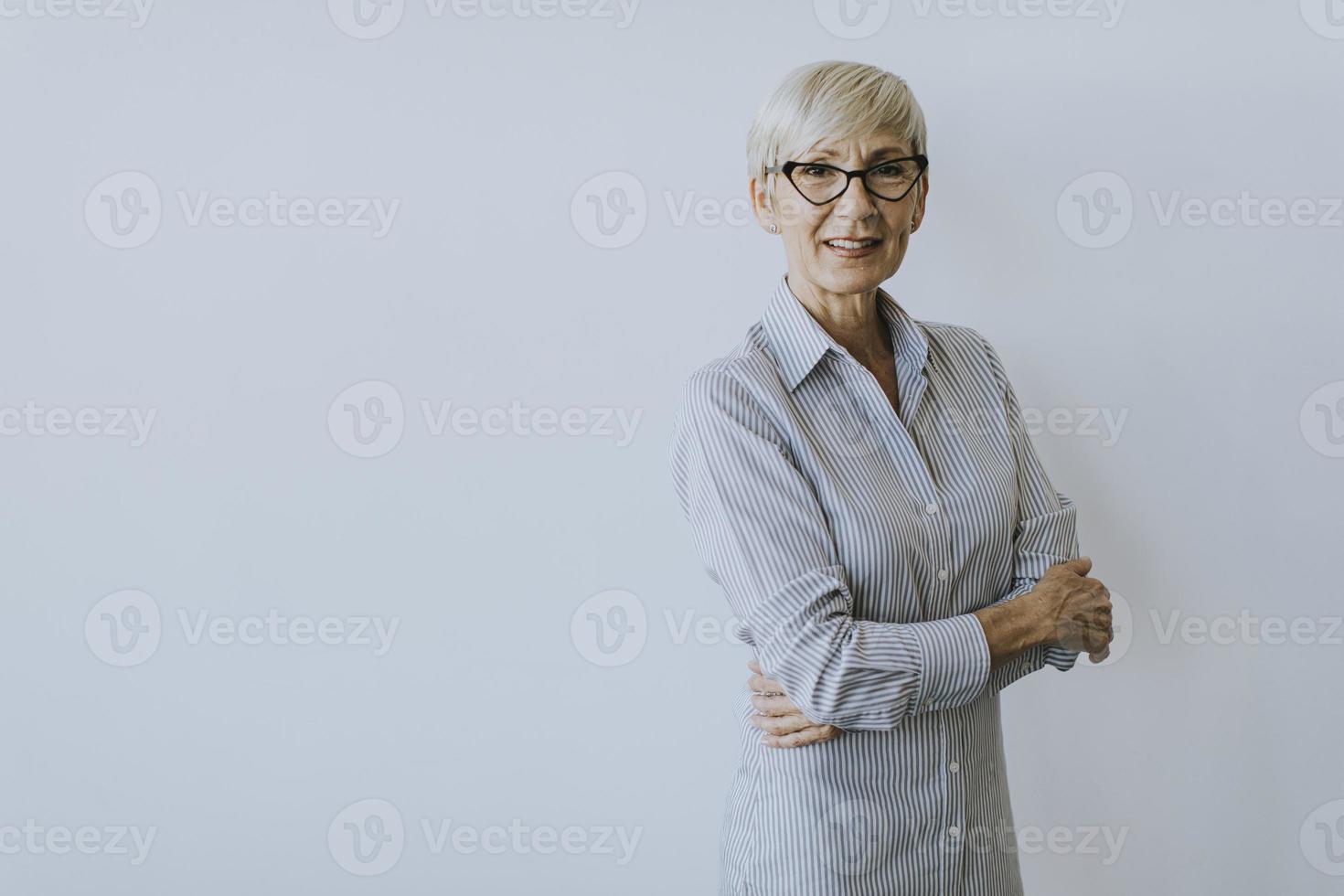 Close-up of mature businesswoman with arms crossed photo