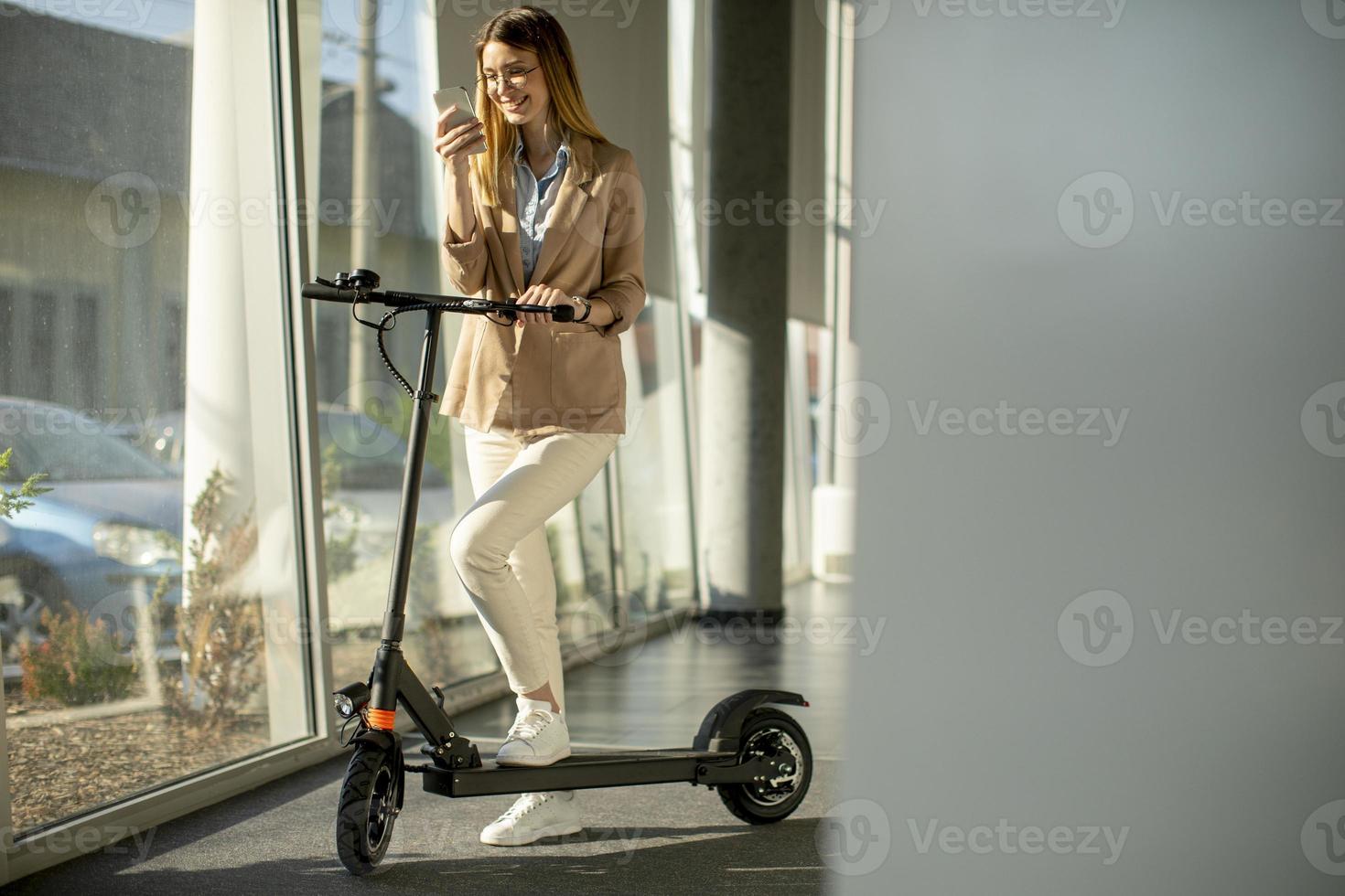 Woman with scooter in office photo