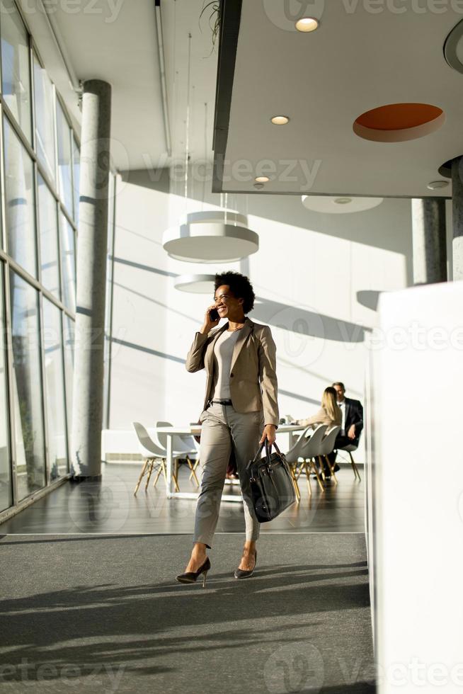 Businesswoman walking and talking on phone photo