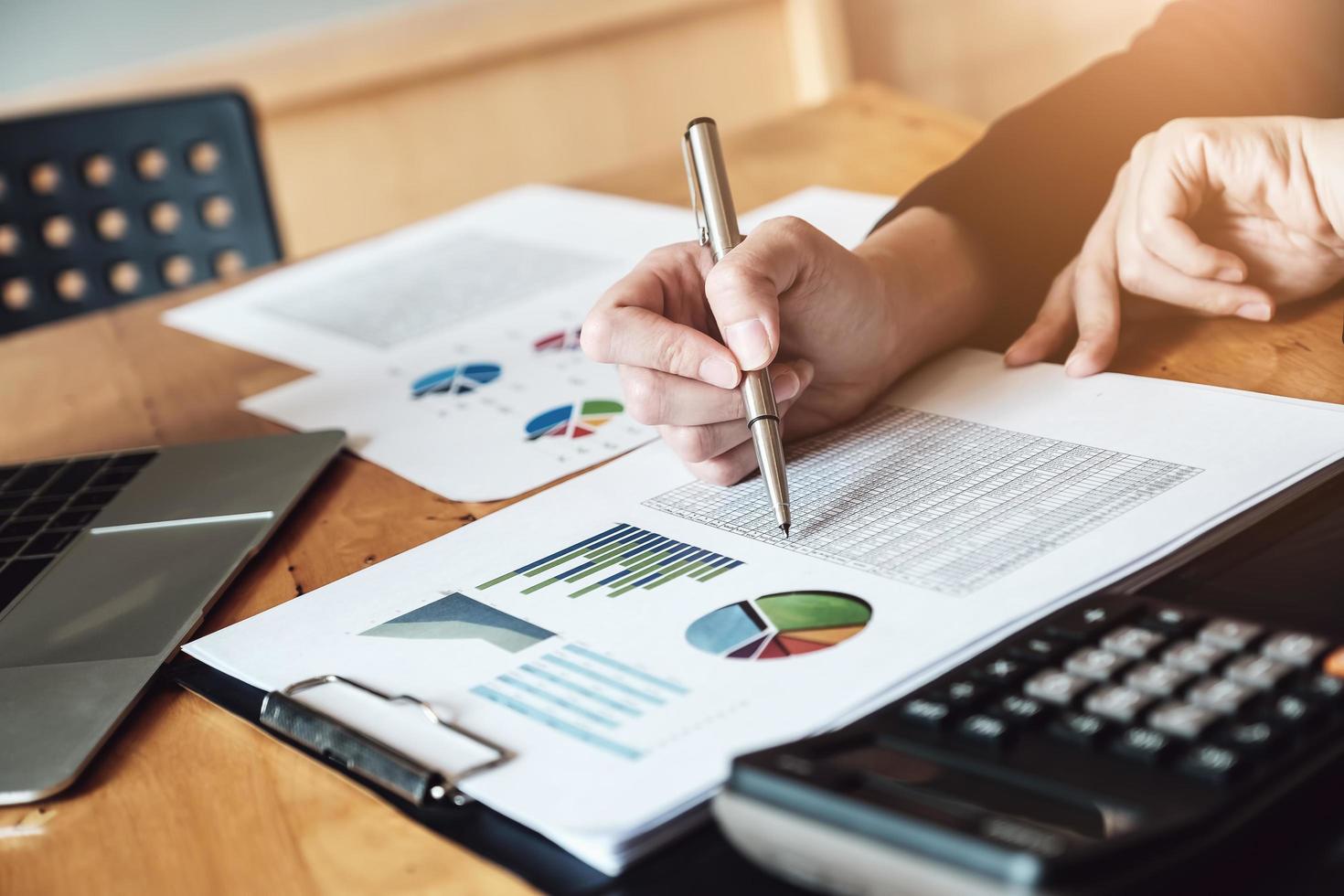 female businessmen analyze and auditor documents with using computer laptop and calculator to calculating budget documents to company directors photo