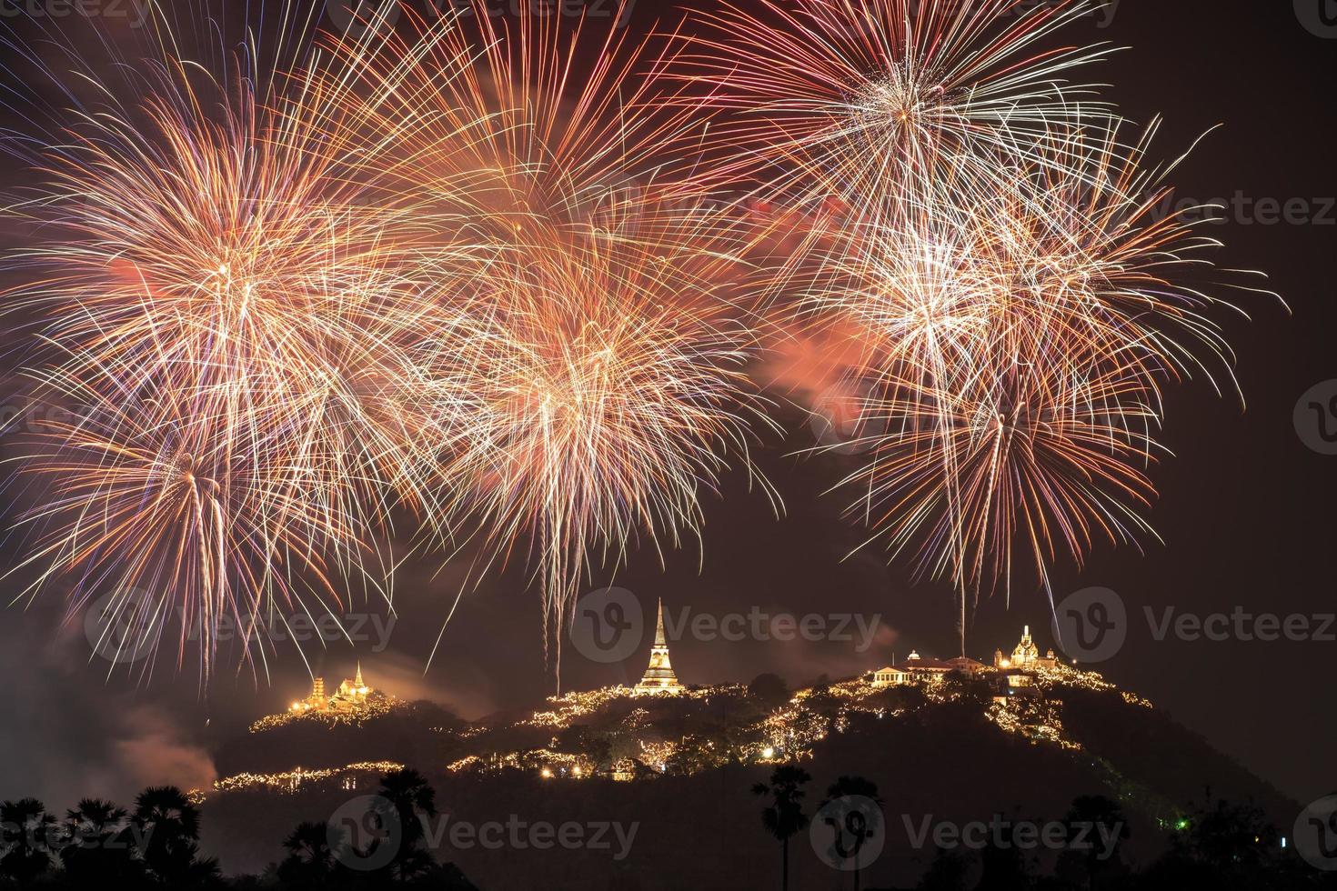 Annual festival of Khao Wang temple with colorful fireworks on hill at night photo