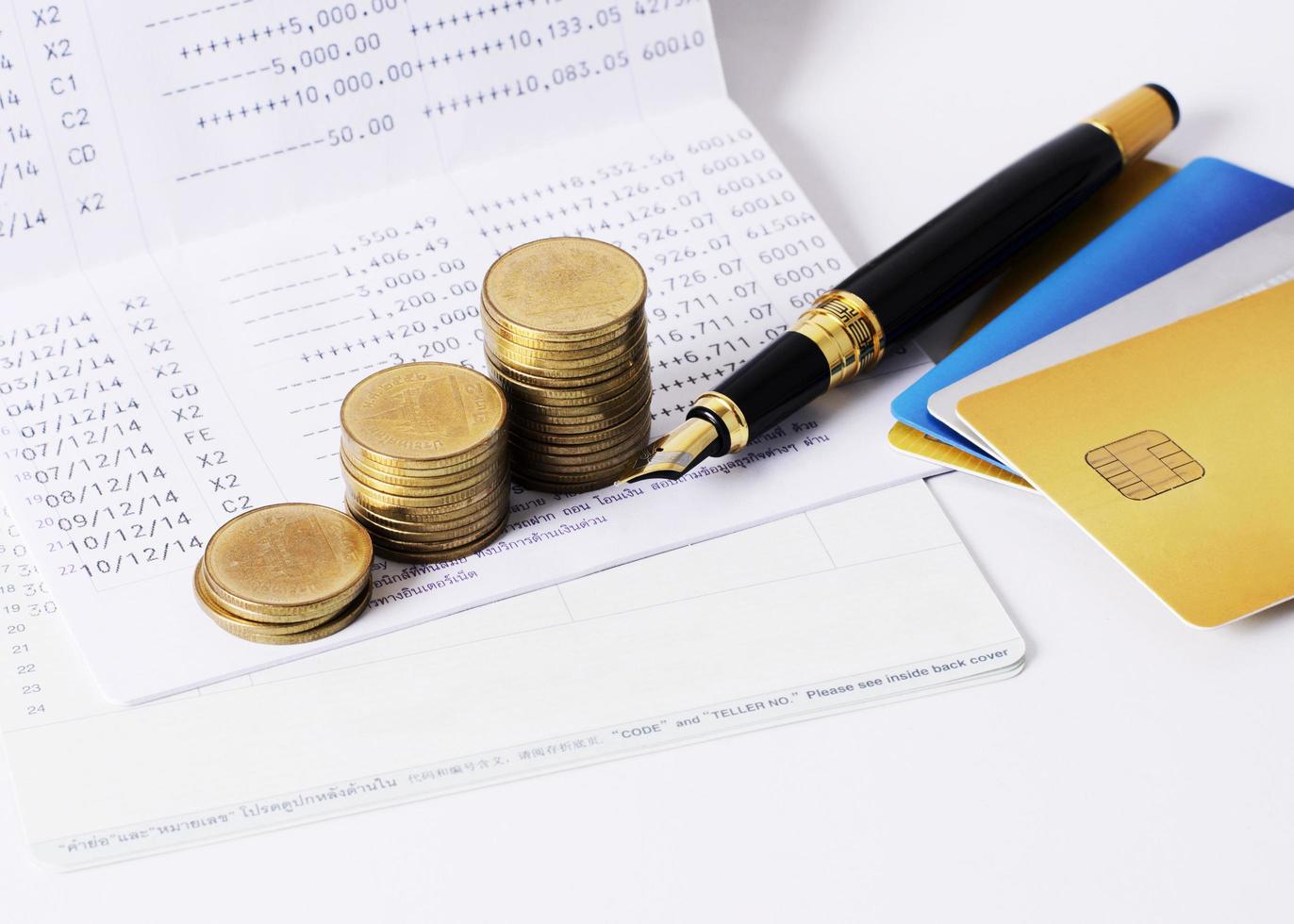 Coins stack and fountain pen with book savings background photo