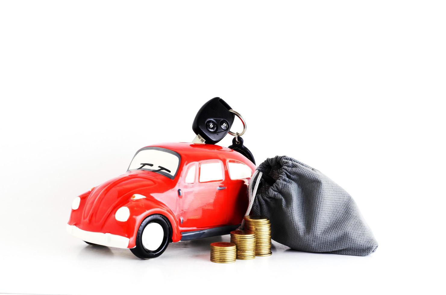 Car bank and money bag with coins stack for car loan concept photo