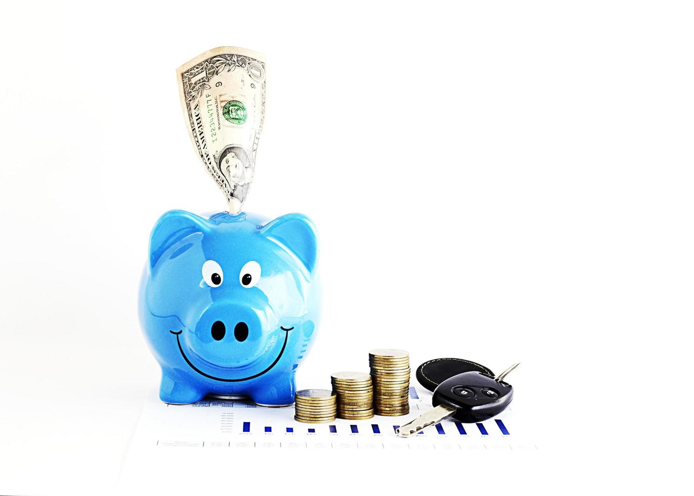 Dollar banknote into piggy bank and coins with car keys for saving money concept photo