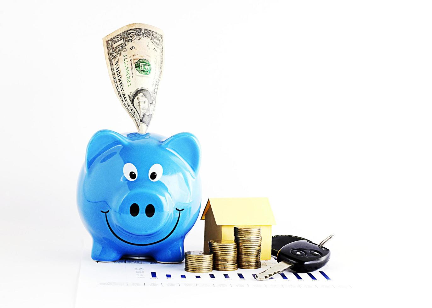 Piggy bank with dollar and coins stack and home paper with car keys for loan money concept photo