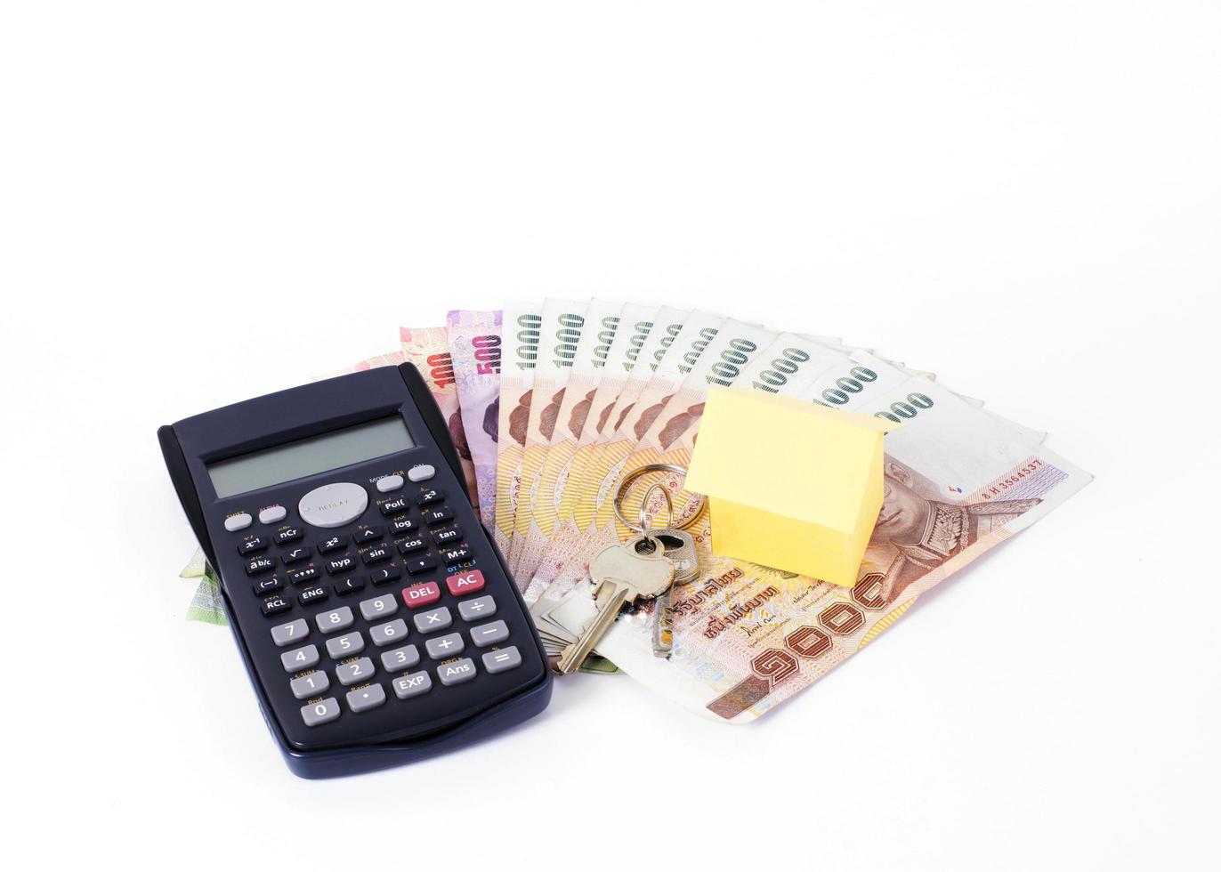 Calculator and home paper  with keys on Thai money banknote for loans concept photo