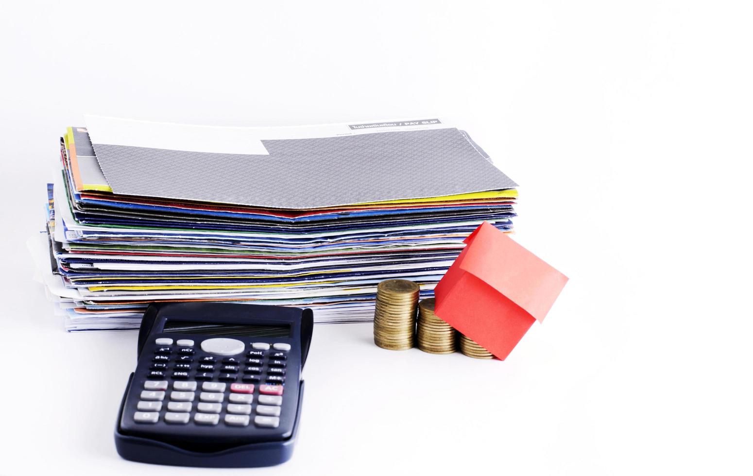 Loans concept with bill payment and calculator with house papers and coins photo