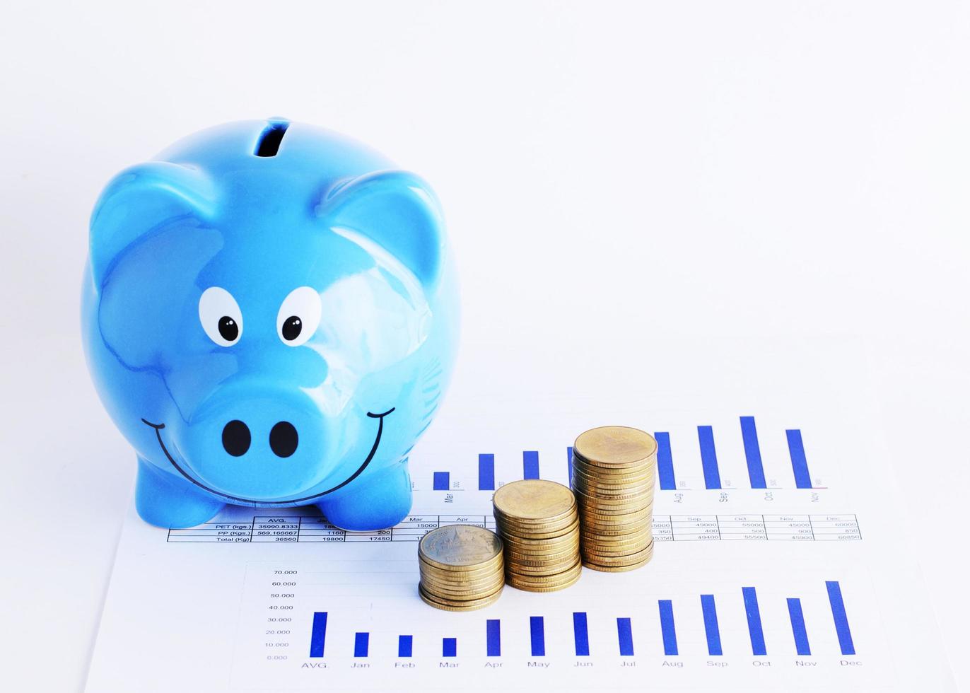 Blue piggy bank with coins stack on chart for saving money concept photo