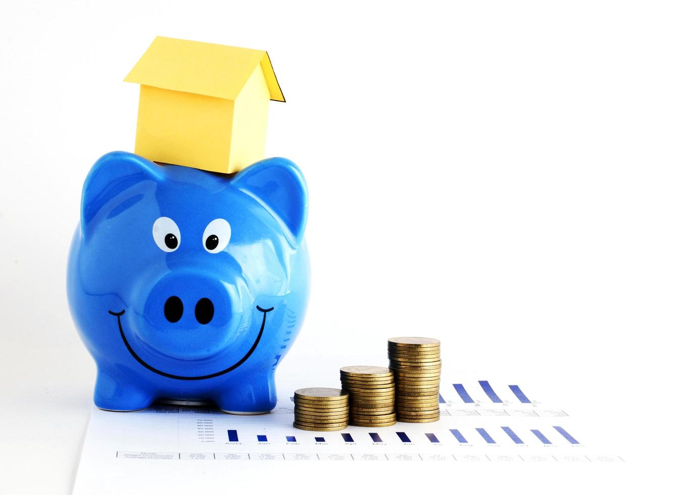 Piggy bank and house paper and coins stack for home loans concept photo