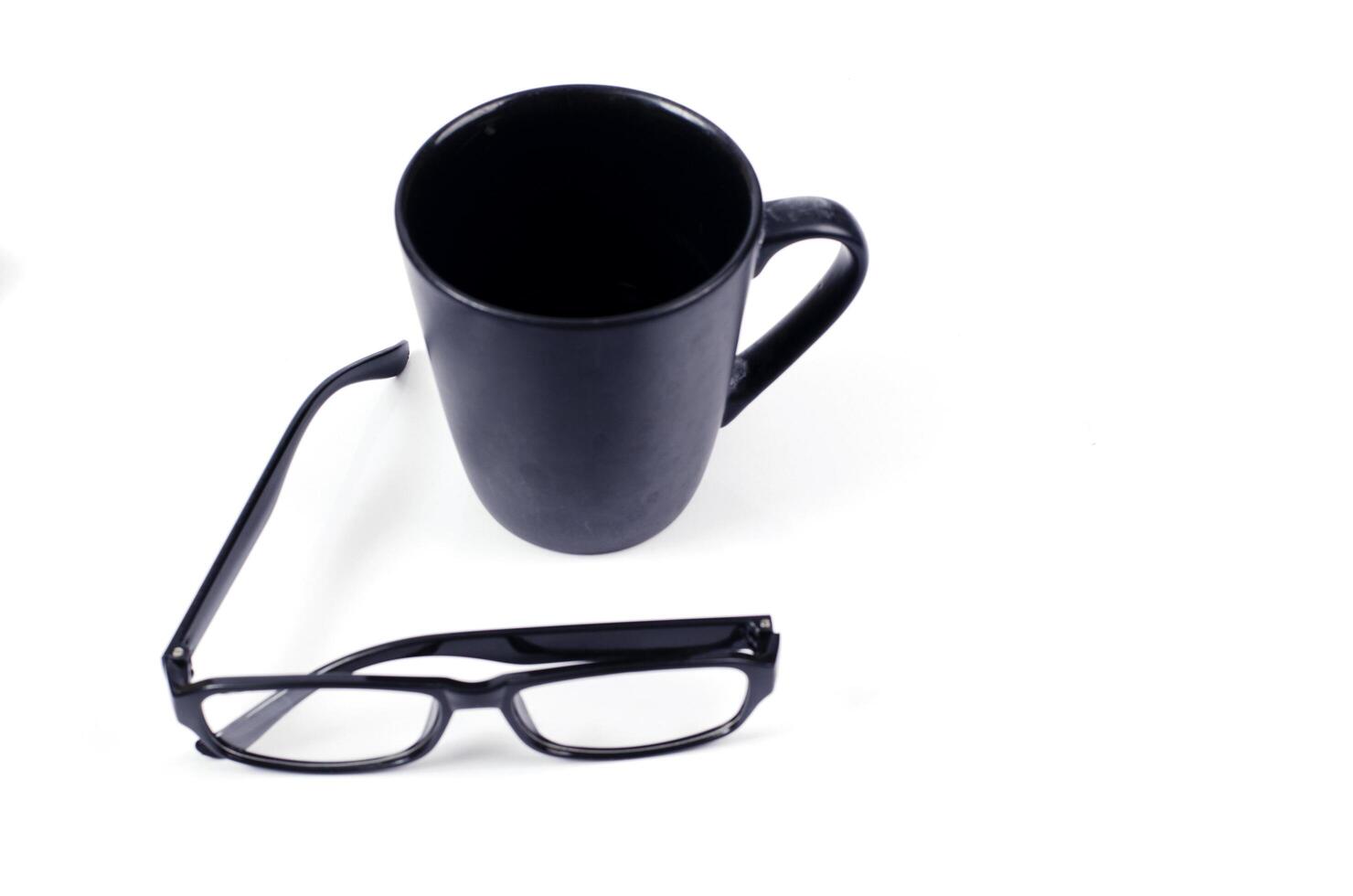 Minimalist style with coffee cup and eyeglasses on white background photo