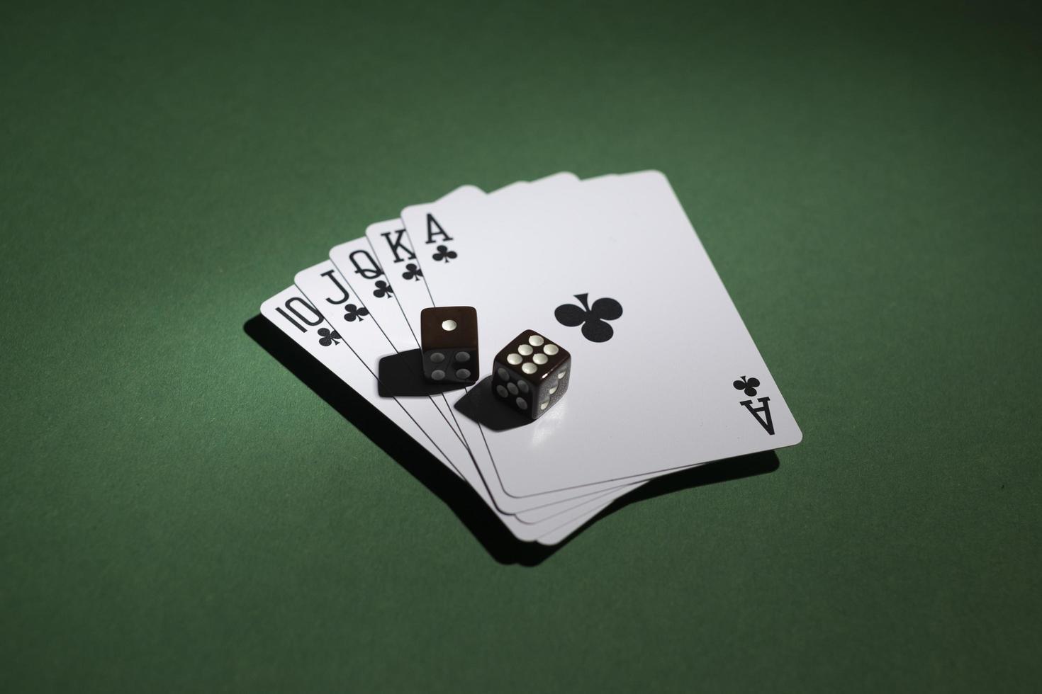 Royal flush cards with dice on green background photo