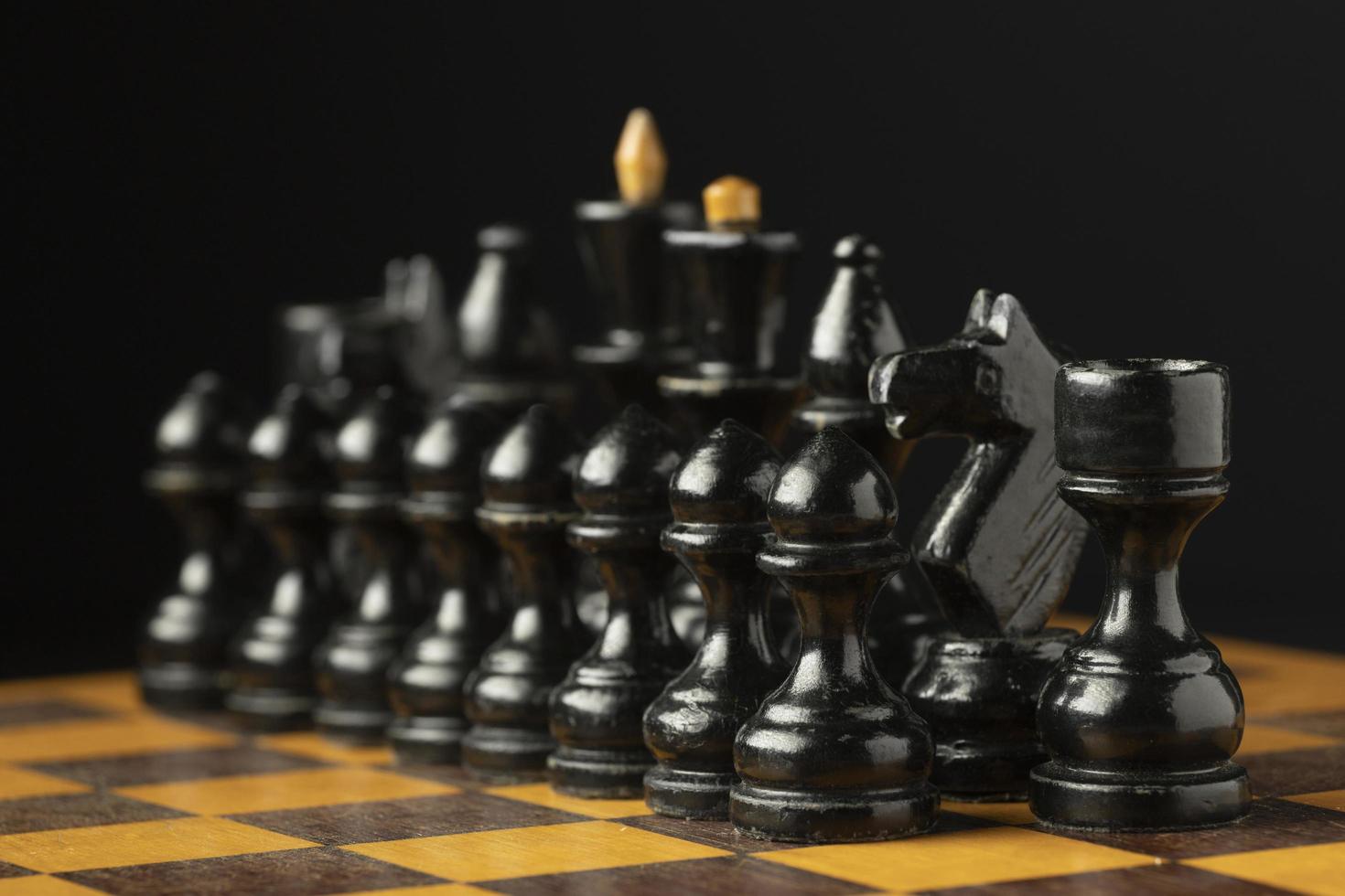 Black chess pieces on chess board photo