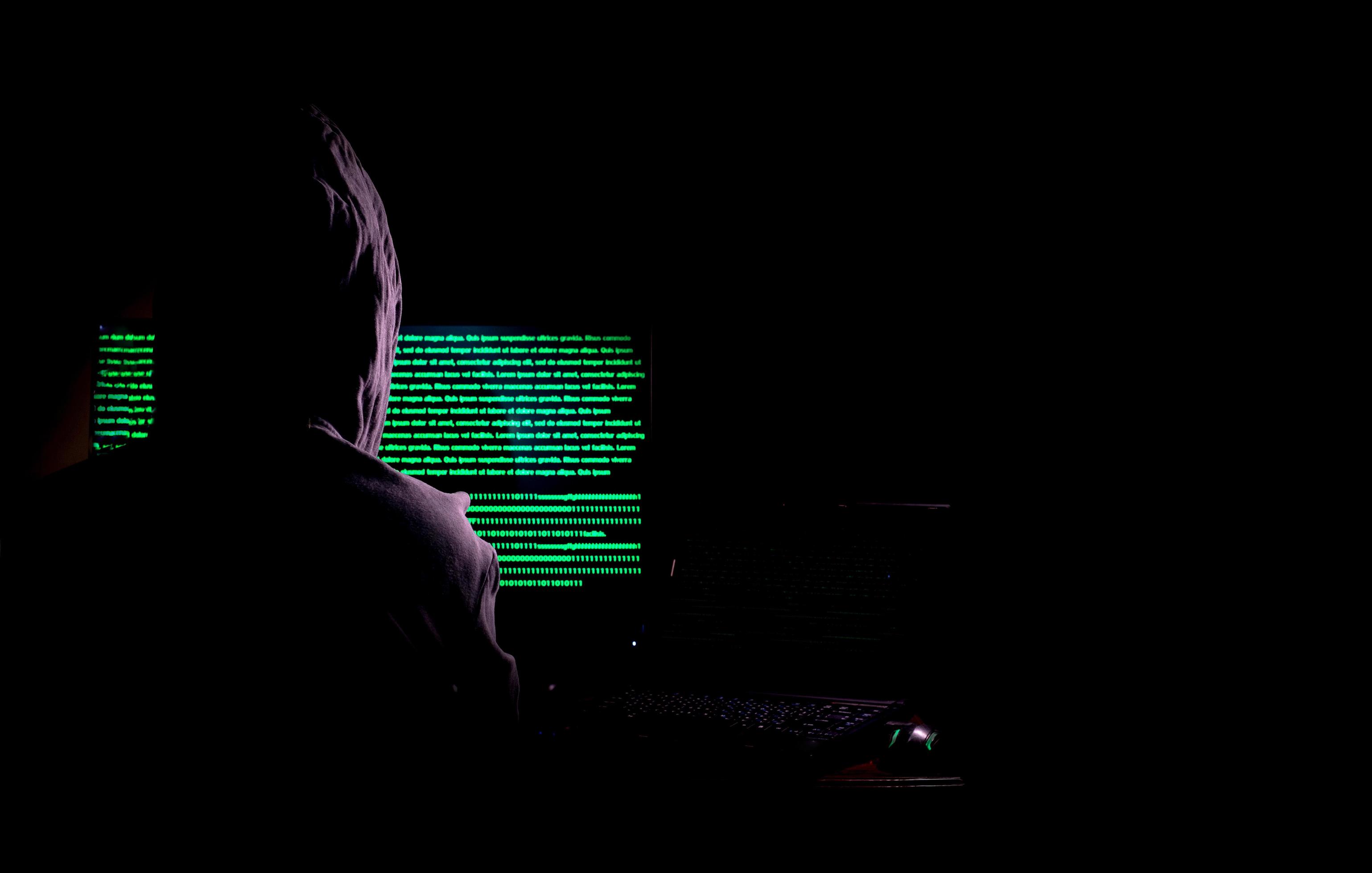 Women hacker breaks into government data servers and infects their system with a virus at his hideout place, dark blue atmosphere, hooded lady using laptop with binary code background, malware concept 2411565 Women hacker breaks into government data servers and infects their system with a virus at his hideout place, dark blue atmosphere, hooded lady using laptop with binary code background, malware concept 2411565