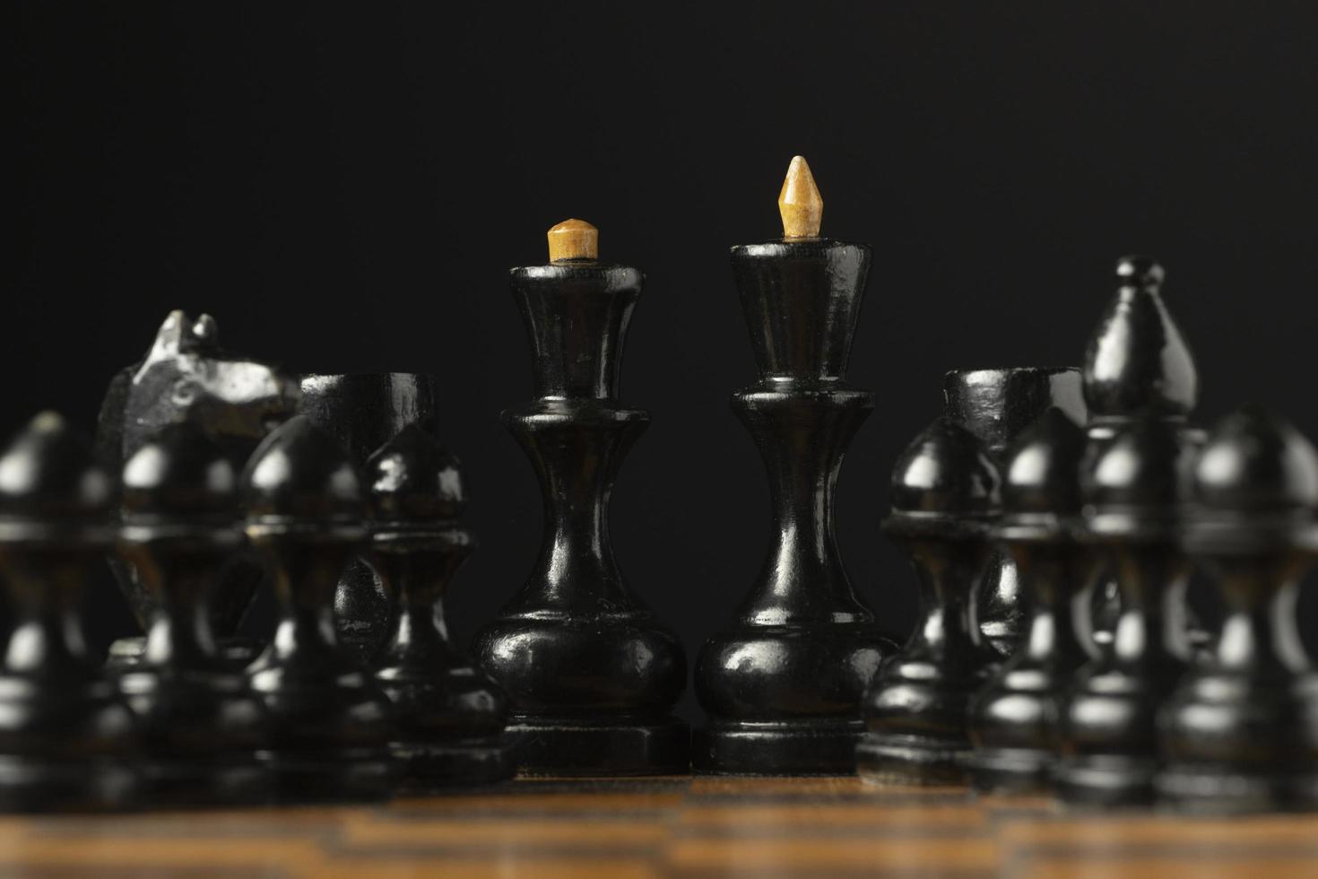 Black chess pieces on chess board photo