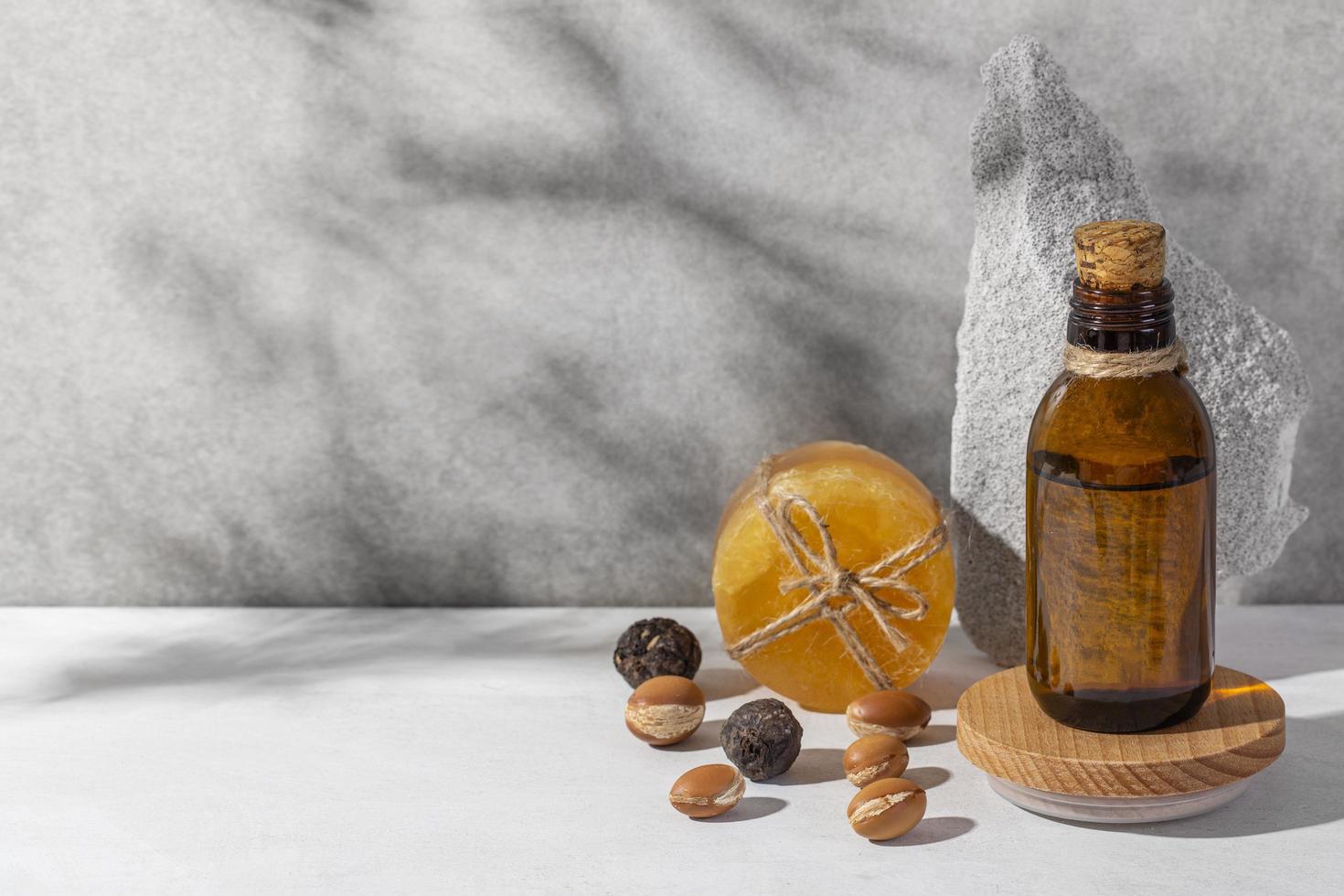 Minimal background of argan oil care composition photo