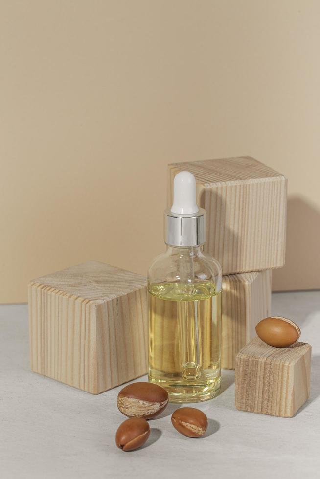 Minimal background of argan oil care composition photo