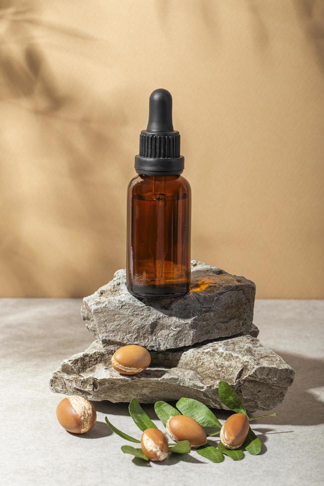 Minimal background of argan oil care composition photo