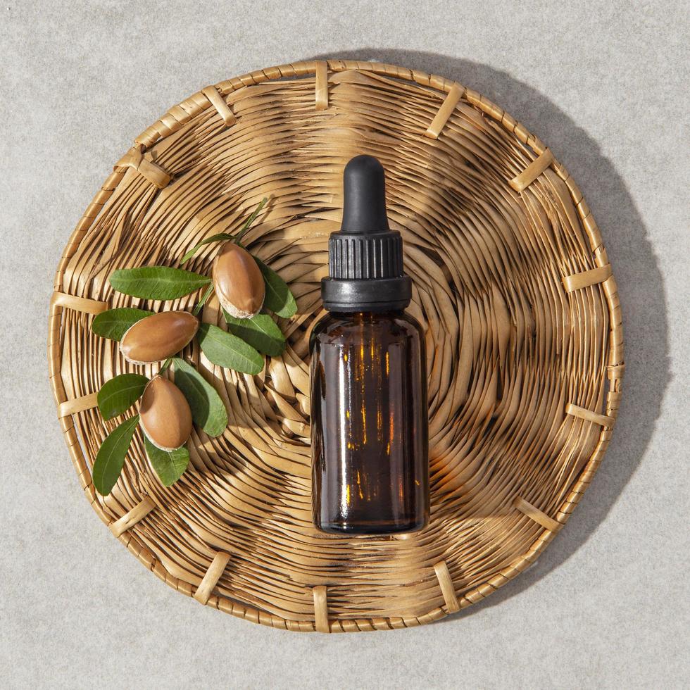 Minimal background of argan oil care composition photo