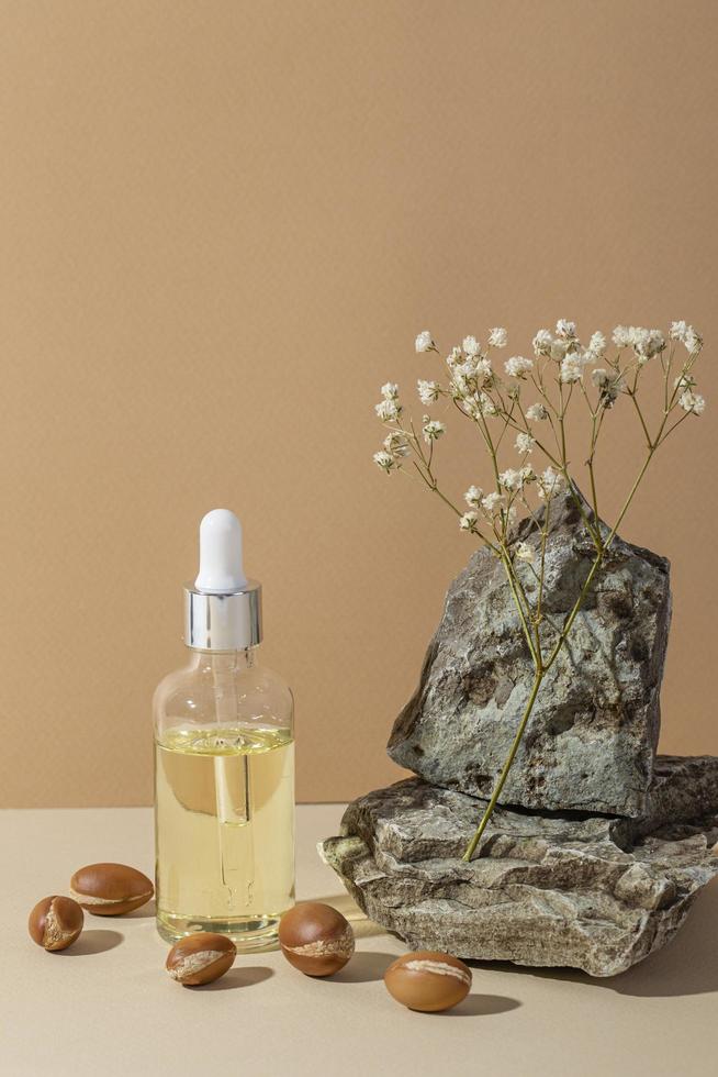 Minimal background of argan oil care composition photo