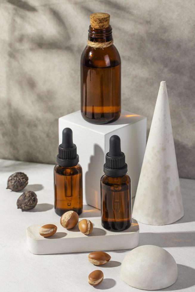 Minimal background of argan oil care composition photo