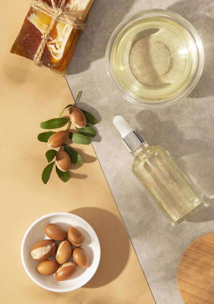 Minimal background of argan oil care composition photo