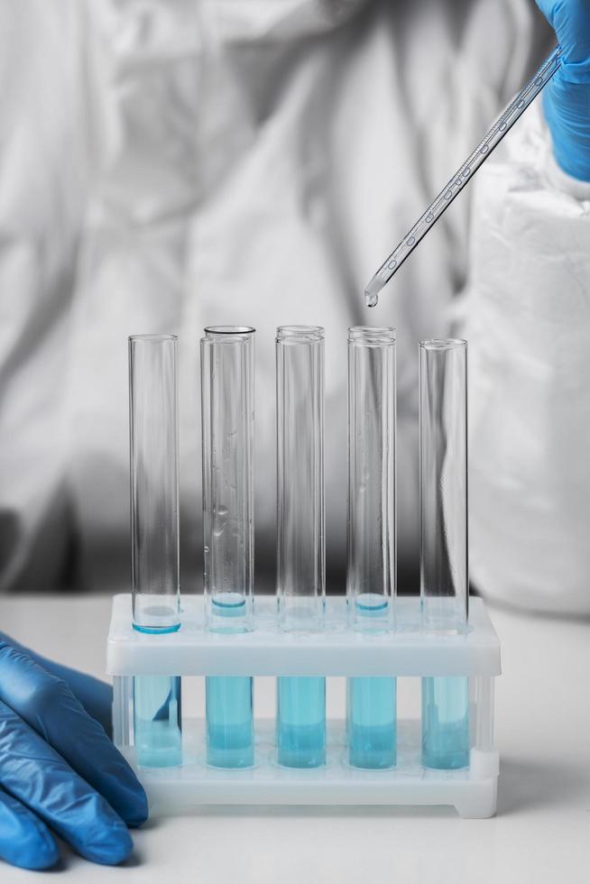 Doctor in protective suit making tests in lab photo