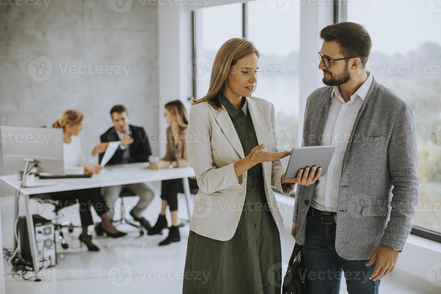 Man and woman in discussion with a tablet photo