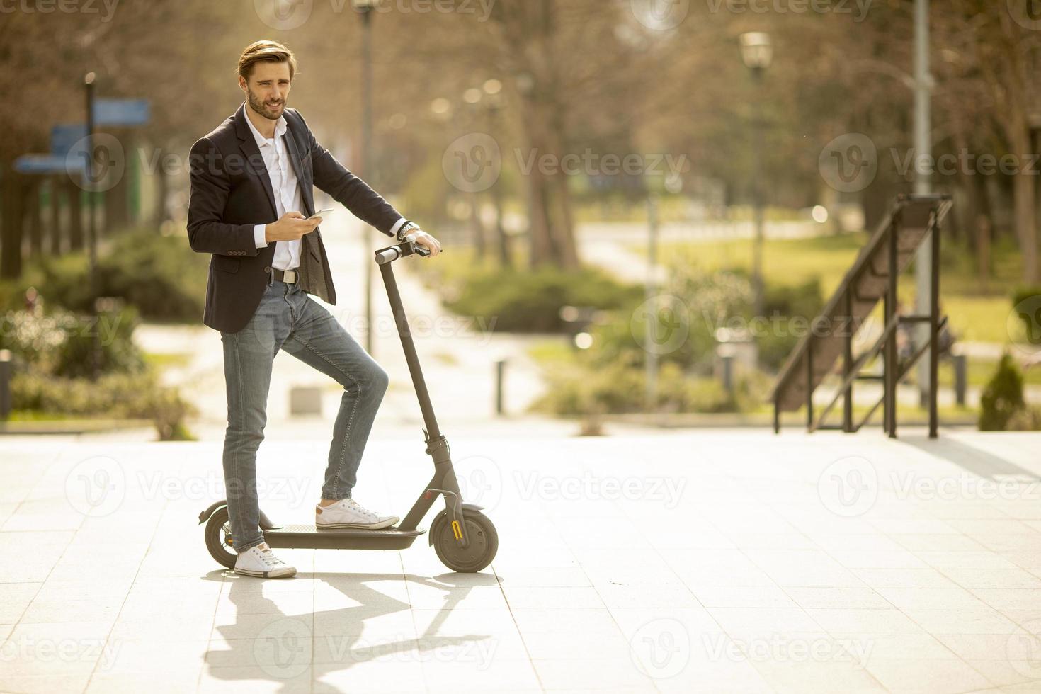 Man on scooter outside photo