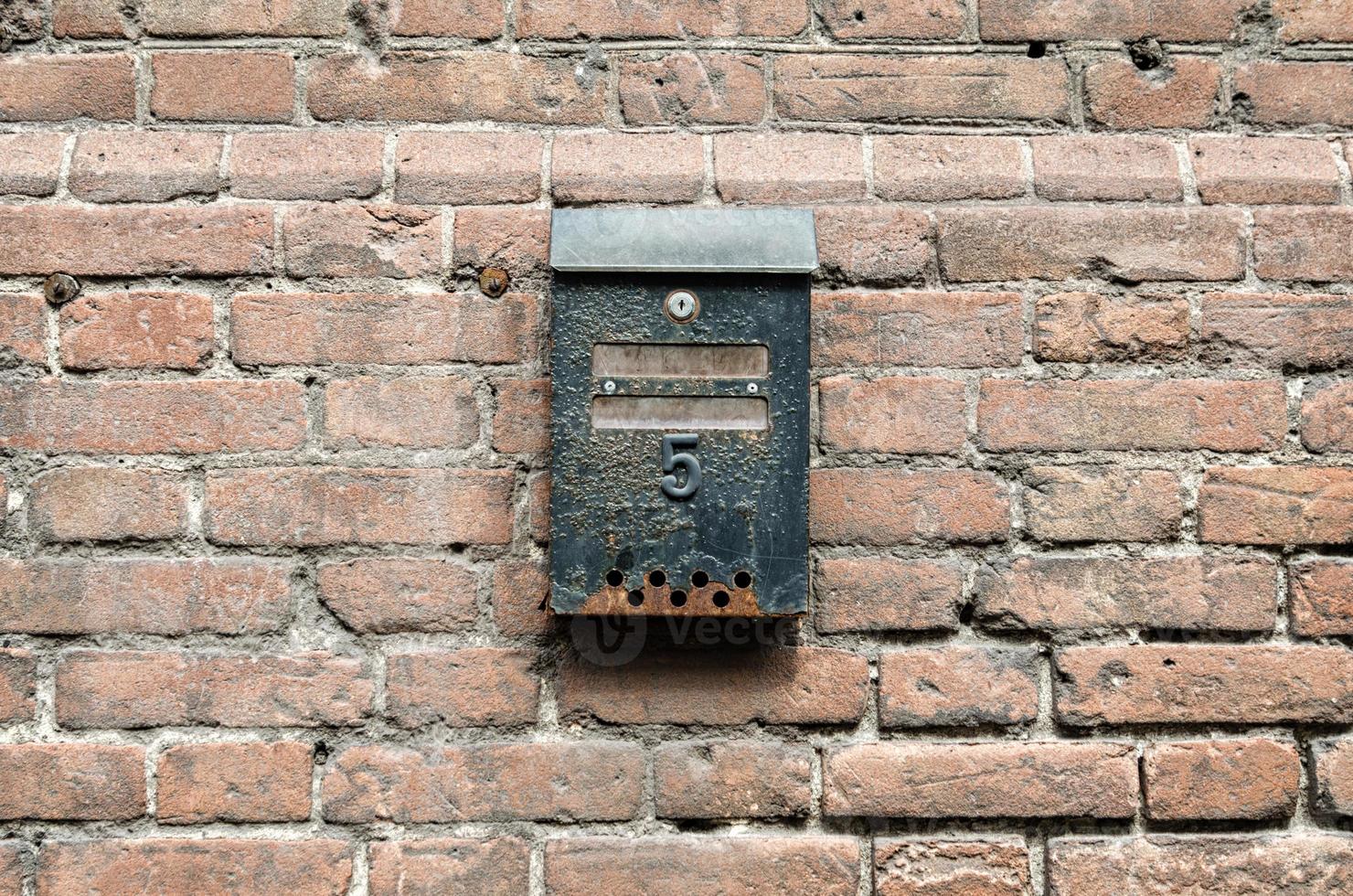 Old rusty letterbox with number five photo