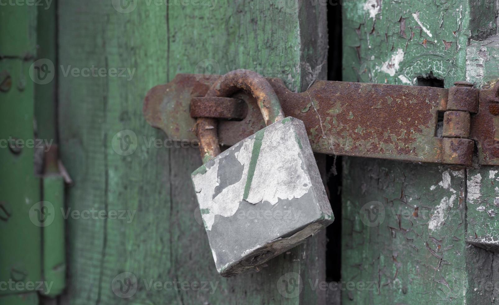 Old vintage lock on a wooden door photo