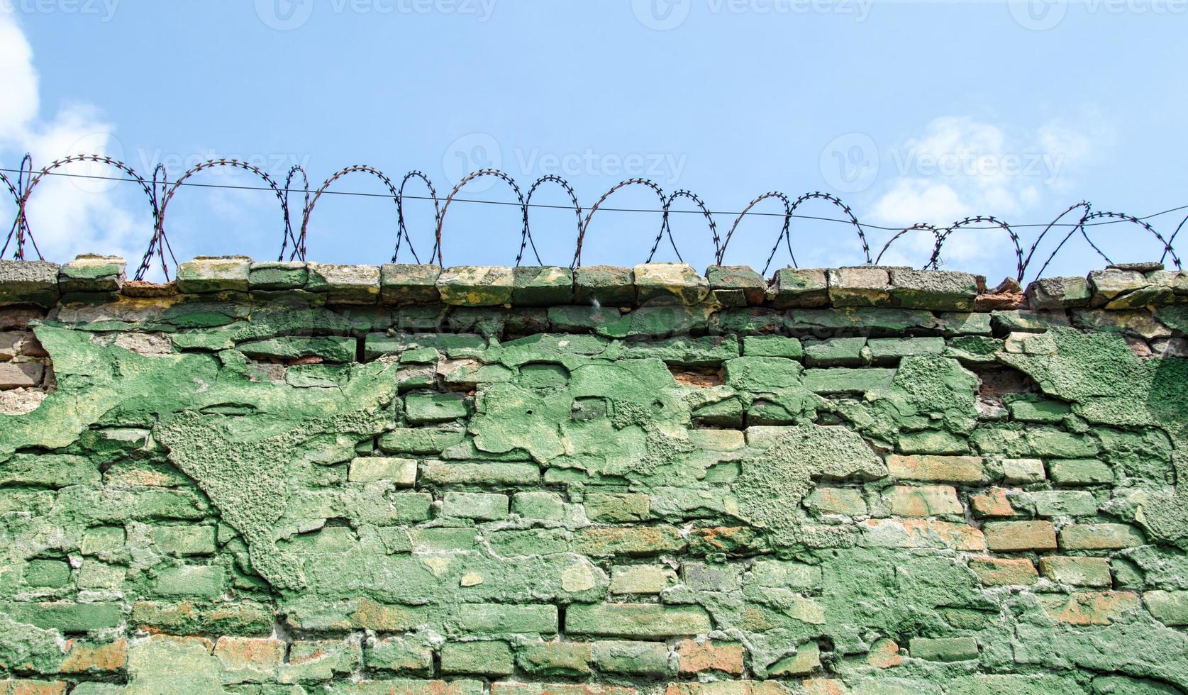 Barbed wire on blue sky background photo