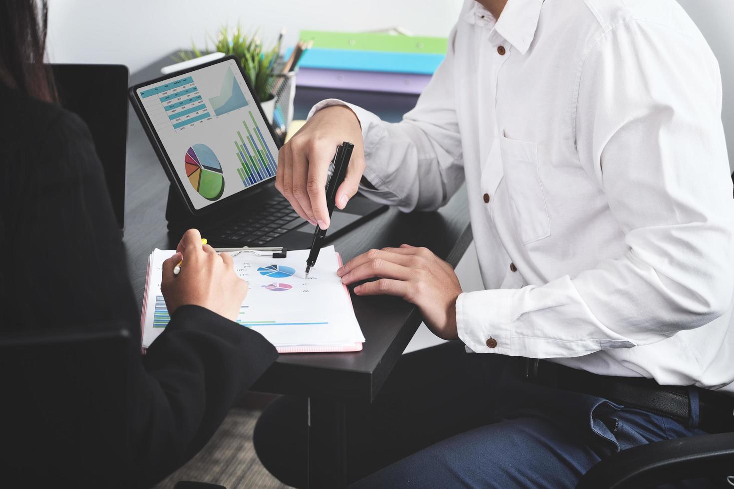 Two young business executives are discussing to change their business concept to increase profits and the strength of their business photo