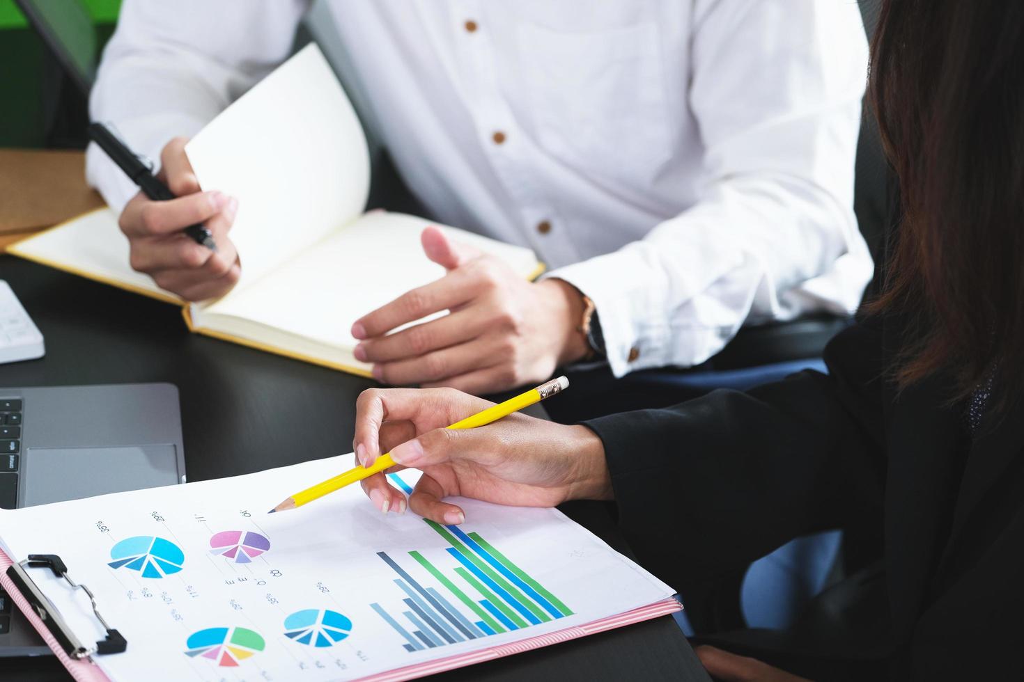 Two young business executives are discussing to change their business concept to increase profits and the strength of their business. photo