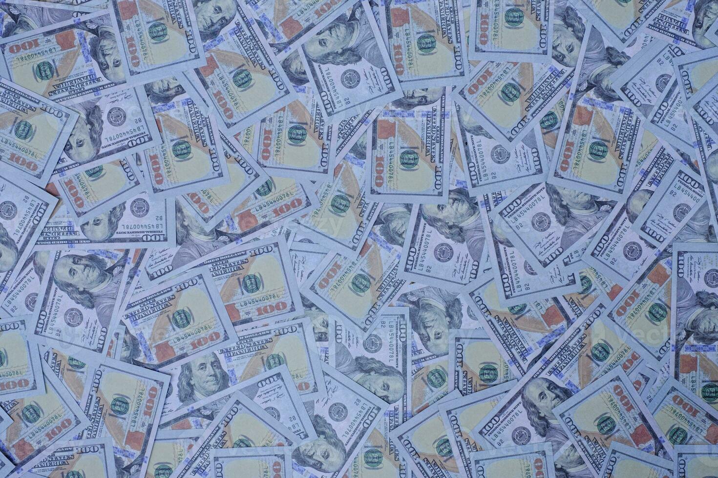 Group of money stacks of 100 US dollars banknotes as a background texture photo