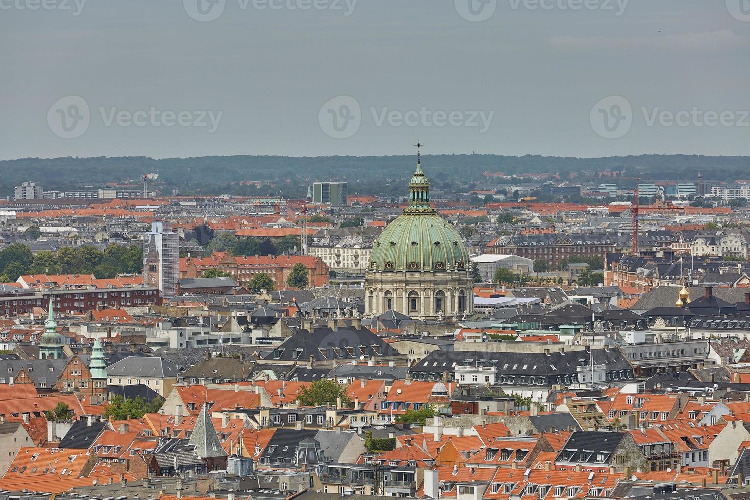 Skyline of scandinavian city of Copenhagen in Denmark during a cloudy day photo