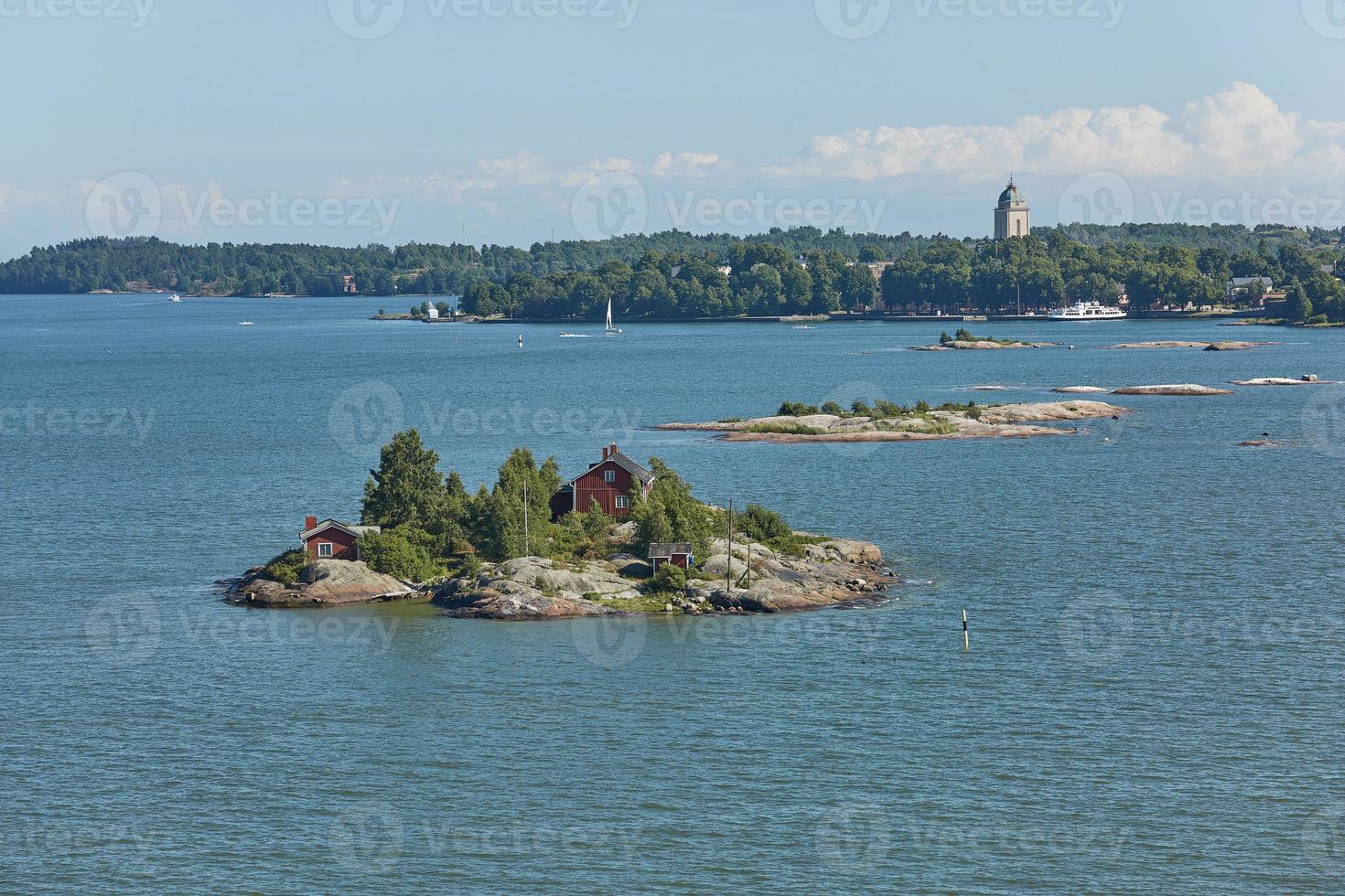 Houses surrounded by water and the banks of the Gulf of Finland near the port of Helsinki in Finland photo