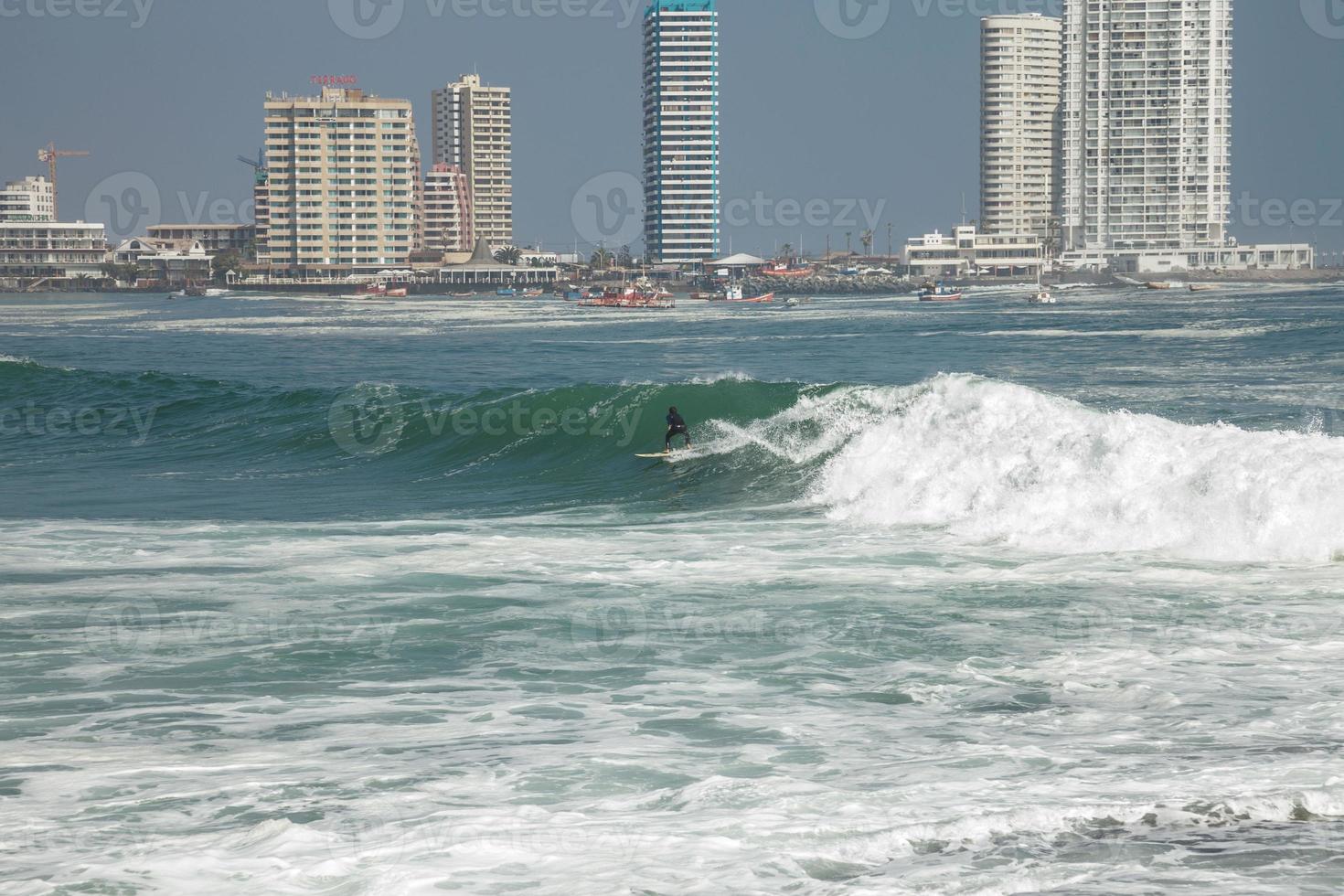 Man surfing on a wave in Iquique Chile photo