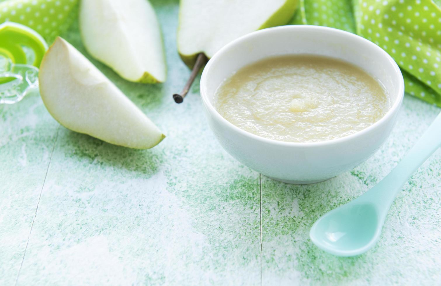 Bowl with fruit baby food and pears photo