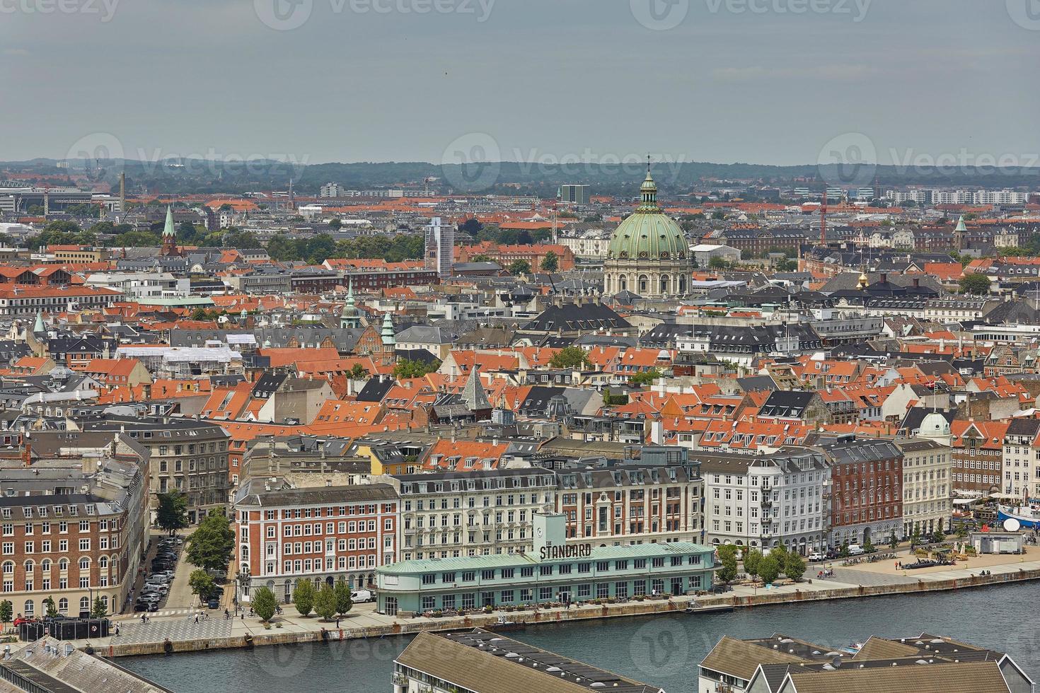 Skyline of scandinavian city of Copenhagen in Denmark during a cloudy day photo